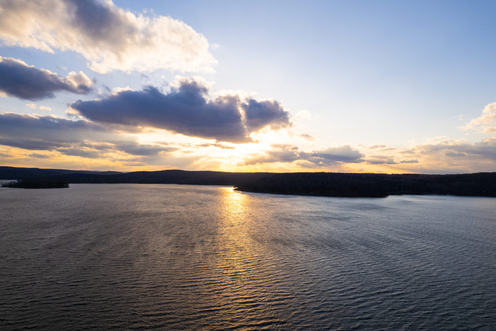 View of the sun set, mountains, and river