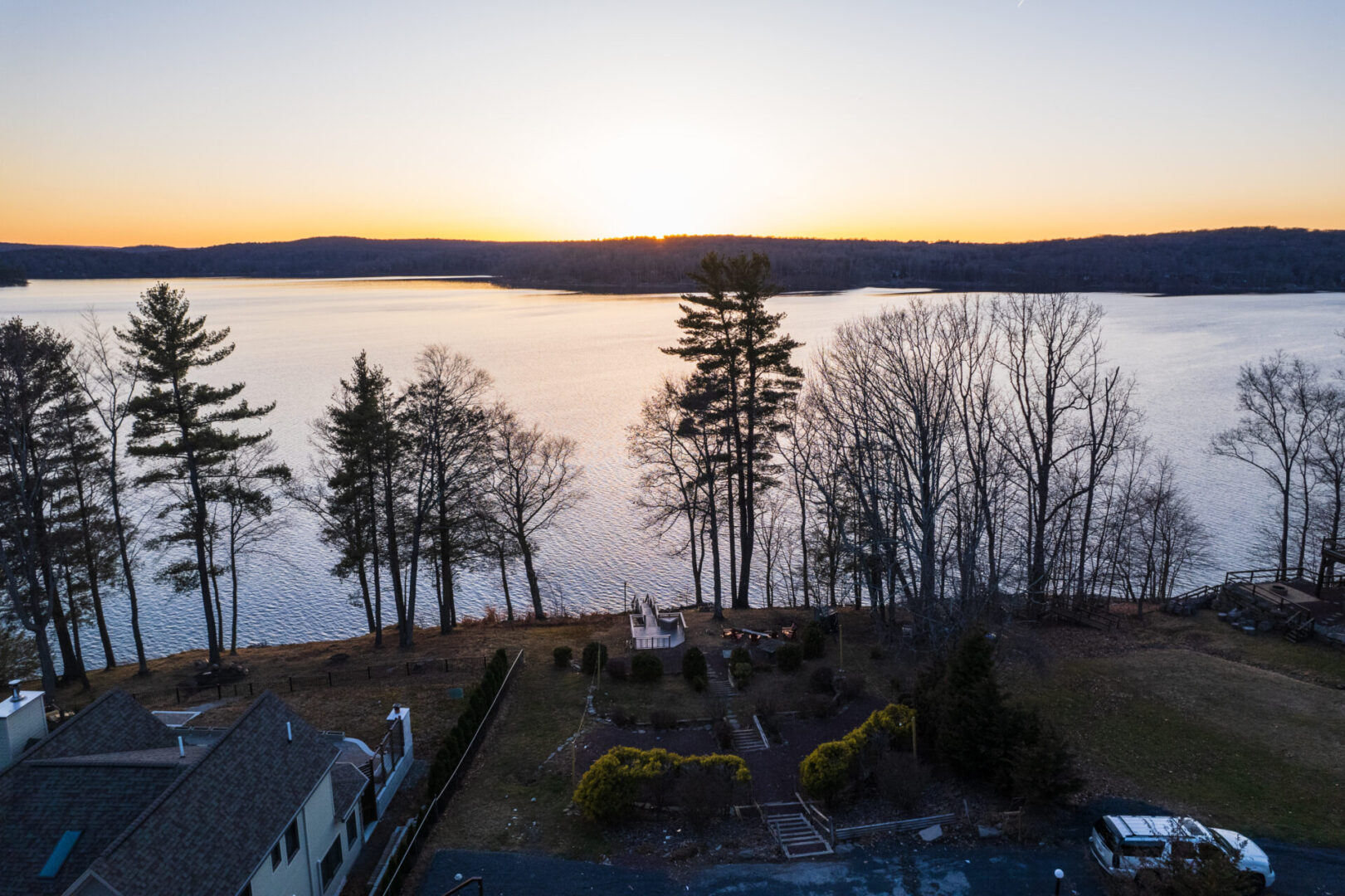 Drone view of the house, trees, and river